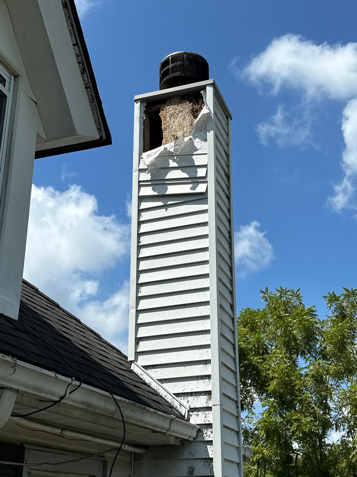 Damaged siding before repair