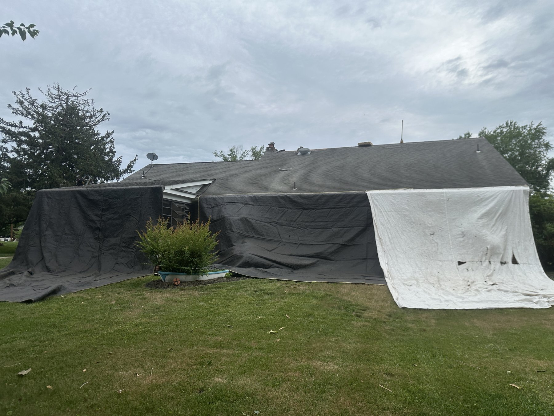 Home in Mickleton NJ protected with mesh roofing tarps before roof tear-off