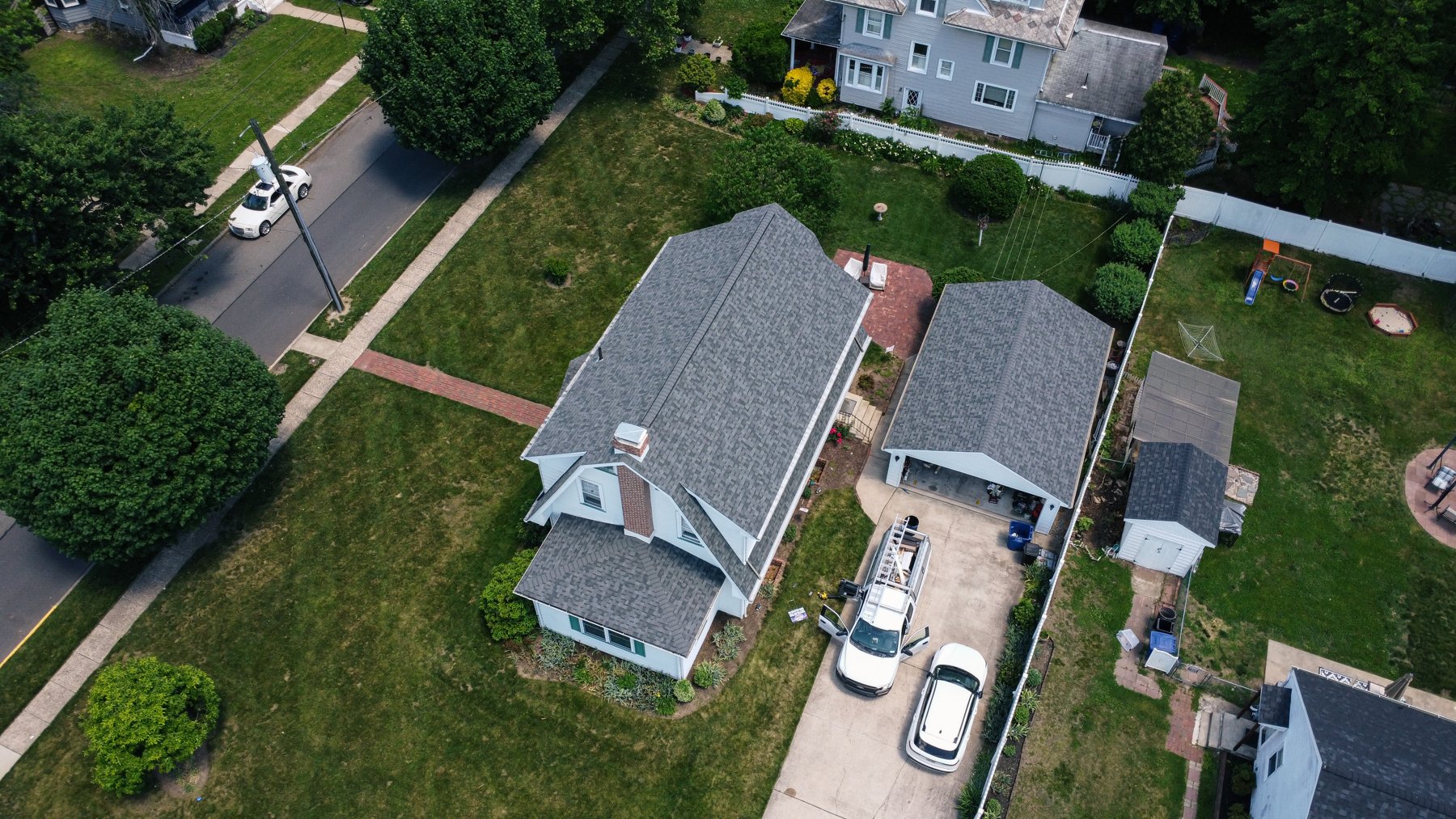 Aerial drone view of completed Estate Gray roof replacement on house and detached garage in Pitman NJ