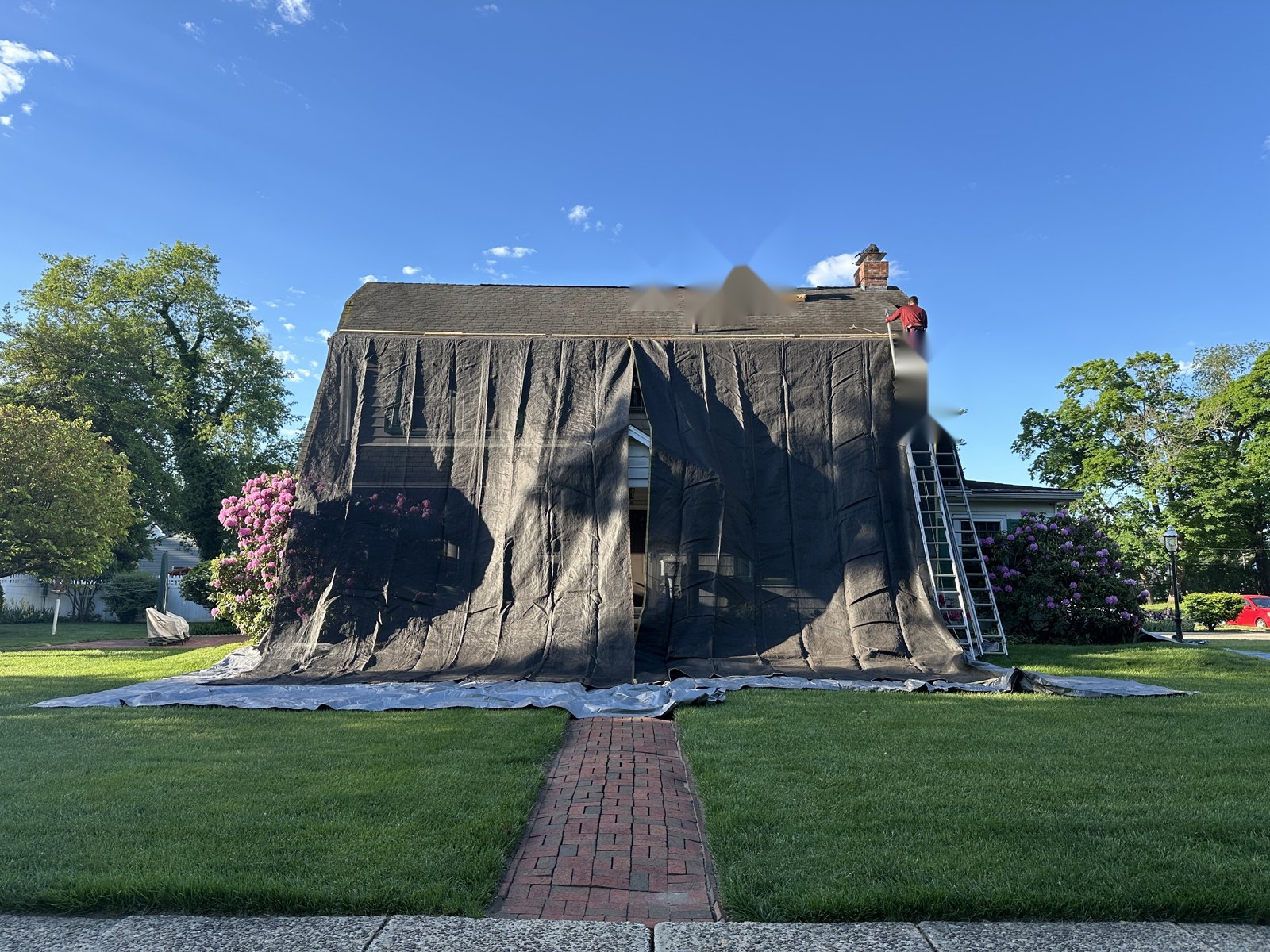 Home in Pitman NJ fully protected with mesh roofing tarps before tear-off
